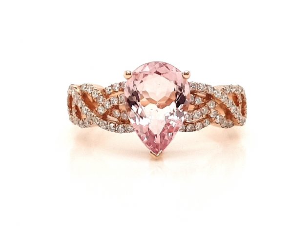 Pear Cut Morganite and Diamond Cluster Dress Ring; central 1.75 carat pear-shaped morganite flanked by 0.33cts diamond set overlapping waves and swirls, in 18ct rose gold
