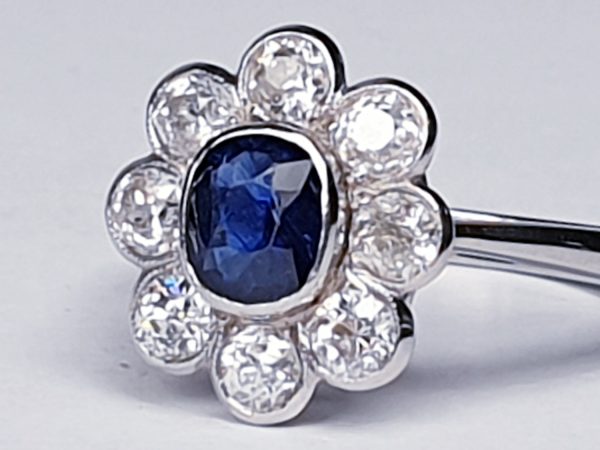 Vintage Sapphire and Old Cut Diamond Flower Cluster Ring; central 0.75 carat natural royal blue sapphire surrounded by 1.40cts old cut diamonds, on a new platinum shank