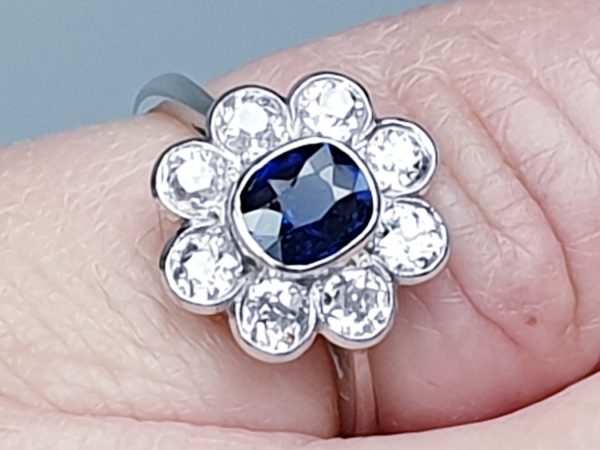 Vintage Sapphire and Old Cut Diamond Flower Cluster Ring; central 0.75 carat natural royal blue sapphire surrounded by 1.40cts old cut diamonds, on a new platinum shank