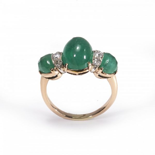 Vintage Cabochon Emerald and Diamond Three Stone Ring; central 2.80ct cabochon-cut emerald, flanked by fancy faceted emeralds and round brilliant-cut diamonds, claw set in yellow gold. Circa 1950
