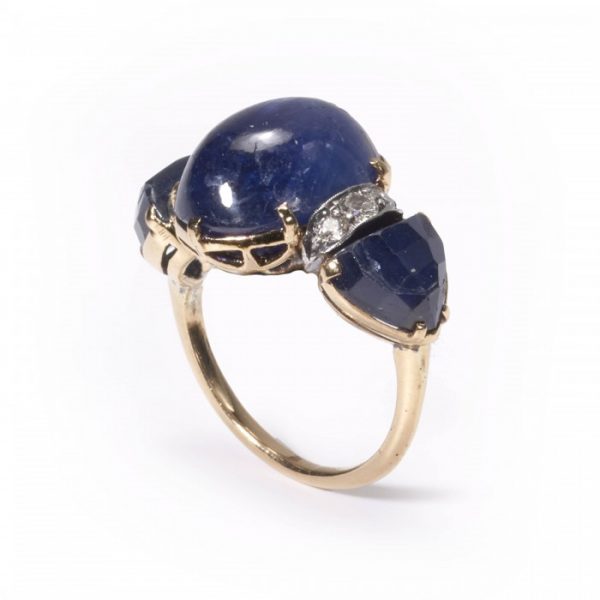 Vintage 1950s Cabochon Sapphire and Diamond Three Stone Ring, 9.00ct cabochon sapphire flanked by fancy faceted sapphires and brilliant diamonds