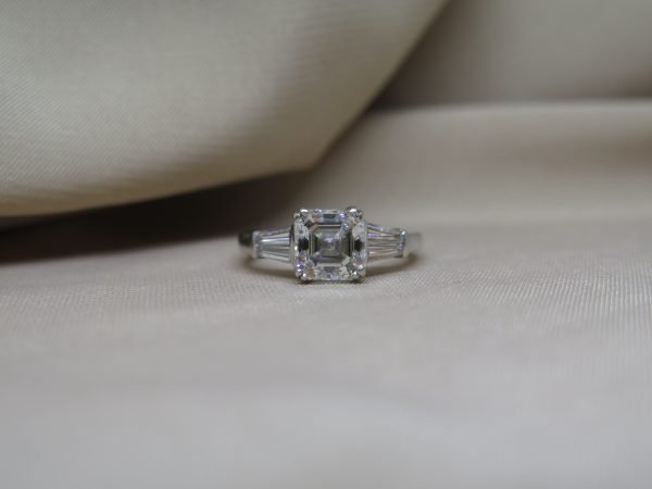 1.80ct Asscher Cut Diamond Ring in Platinum with Tapered Baguette Shoulders; central 1.80 carat asscher-cut diamond flanked either side by a tapered baguette-cut diamond set to the shoulders. Mounted in platinum