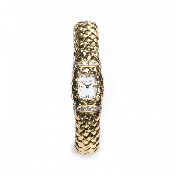 Tiffany and Co Vannerie Diamond and 18ct Yellow Gold Ladies Wristwatch, cushion-shaped white dial with gold Roman numerals at 12, 3, 6 and 9, case set with two rows of round brilliant-cut diamonds, above and below the dial, on a lattice design bracelet, all mounted in 18ct yellow gold, with a quartz movement, clasp is stamped Tiffany & Co., 750, 1995