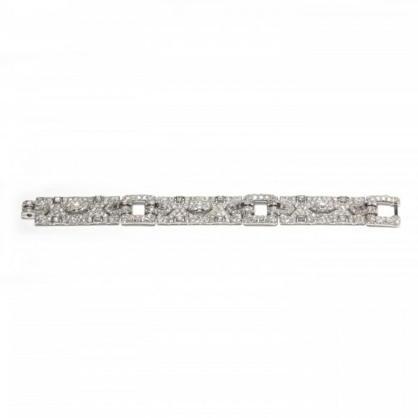 Vintage Cartier Diamond Bracelet; comprised of three panels, each set with a central trap-cut diamond flanked by triangular and fancy-cut diamonds, accented with transitional brilliant-cut and single-cut diamond set surrounds, 18.70 carat total. Mounted in platinum. Circa 1930