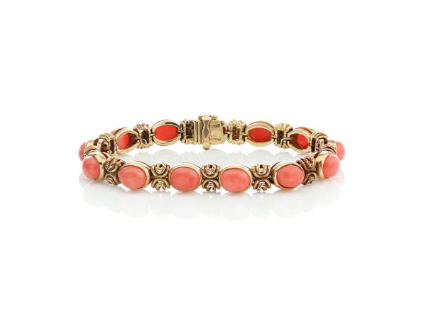 Van Cleef and Arpels Vintage Coral and 18ct Gold Bracelet; set with oval cabochon-cut coral. Made in France, Paris, Circa 1970s