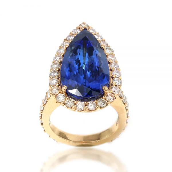 Vintage Pear Cut Tanzanite and Diamond Cluster Ring; 12 carat pear-shaped faceted natural tanzanite surrounded by 2.50cts diamonds, in 18ct yellow gold. Circa 1970s. Comes with GCS certificate