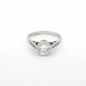Diamond Solitaire Engagement Ring; central 0.90 carat round brilliant-cut diamond, claw set, with diamond set shoulders, in 18ct white gold