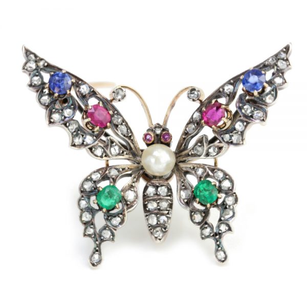 Antique Victorian Multi Gemstone Butterfly Brooch with Natural Pearl; natural freshwater pearl set within a rose-cut diamond encrusted body, accented with blue sapphires, rubies and emeralds. Set in silver and 15ct gold. Made in England, Circa 1860s