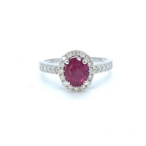 Ruby and Diamond Oval Cluster Engagement Ring; 1.49 carat oval faceted ruby with 0.41cts diamond surround and diamond-set shoulders, in 18ct white gold