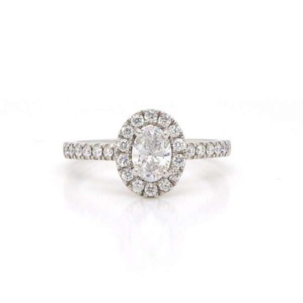 Diamond Oval Cluster Ring in Platinum; central 0.50 carat GIA certified D Colour VS2 clarity diamond surrounded by pavé-set diamonds and diamond-set shoulders