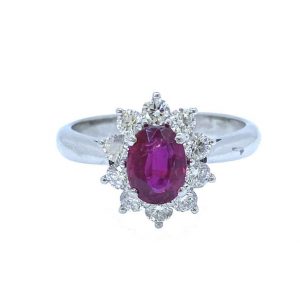 Mozambique Ruby and Diamond Oval Cluster Ring; 1.11 carat oval faceted ruby with no heat treatments surrounded by ten round brilliant-cut diamonds, in 18ct white gold