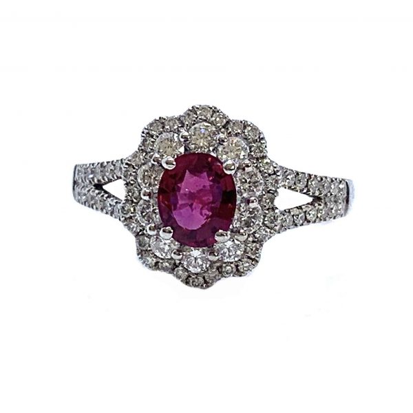 Ruby and Diamond Oval Cluster Dress Ring; 0.99 carat oval faceted ruby within a double diamond surround, diamond-set spilt shoulders, 18ct white gold