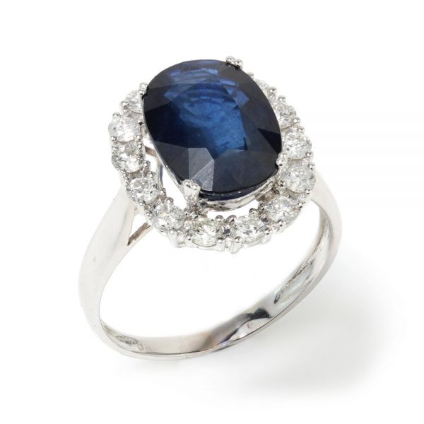 Vintage 1970s Sapphire and Diamond Oval Cluster Ring; 3.50ct oval faceted sapphire surrounded by 0.56cts brilliant-cut diamonds, 18ct white gold