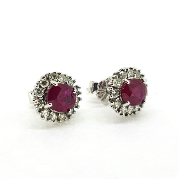 Ruby and Diamond Oval Cluster Stud Earrings; featuring 2.15cts oval faceted rubies surrounded by 0.51cts diamonds, in 18ct white gold