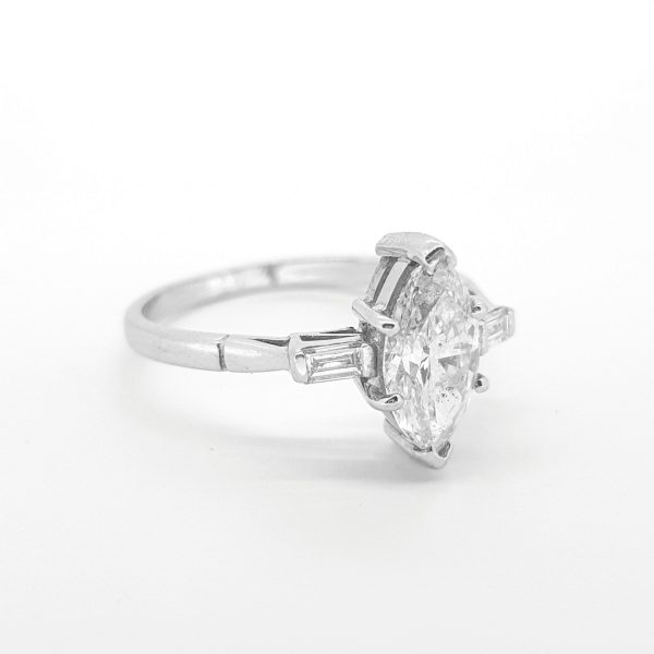 Marquise Cut Diamond Solitaire Engagement Ring; featuring a 1.24 carat marquise-cut diamond flanked by baguette-cut diamonds to the shoulders, in 18ct white gold