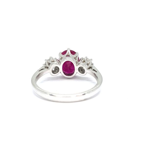 Ruby and Diamond Three Stone Ring; 1.90 carat oval faceted ruby flanked by 0.50cts round brilliant-cut diamonds, claw set in 18ct white gold