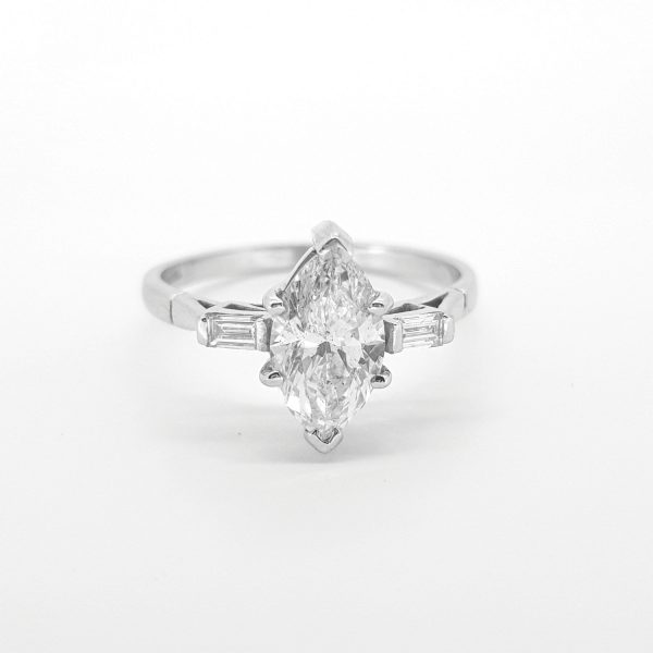 Marquise Cut Diamond Solitaire Engagement Ring; featuring a 1.24 carat marquise-cut diamond flanked by baguette-cut diamonds to the shoulders, in 18ct white gold