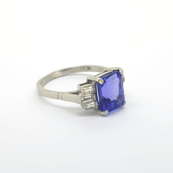 Tanzanite and Baguette Cut Diamond Ring; central 2ct rectangular step cut tanzanite flanked by baguette-cut diamonds set to the shoulders, in 18ct white gold