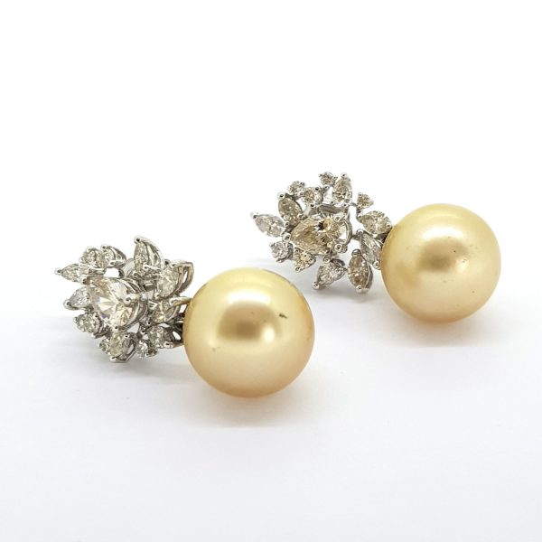 Golden Southsea Pearl Earrings with Diamond Cluster Tops; featuring 13mm golden Southsea pearls suspended from 0.30cts diamond cluster tops in a floral leaf design, in 18ct white gold