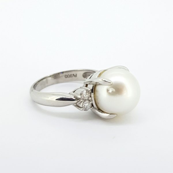 Southsea Pearl and Diamond Ring in Platinum; featuring a 10mm South Sea pearl, claw set, flanked by two diamonds to each side, 0.30 carat total