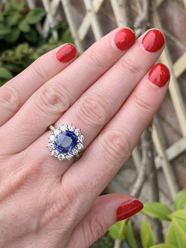 On model finger shot Oval sapphire and diamond large cluster ring weighing 3.14