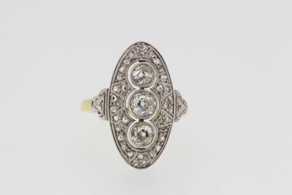 Art Deco Style Diamond Navette Cluster Plaque Ring; three central circular diamonds surrounded by rose-cut diamonds, to an 18ct yellow gold shank