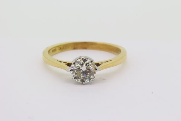 Classic Diamond Solitaire Engagement Ring; 0.73 carat round brilliant-cut diamond set in 18ct white gold, mounted to a plain 18ct yellow gold shank