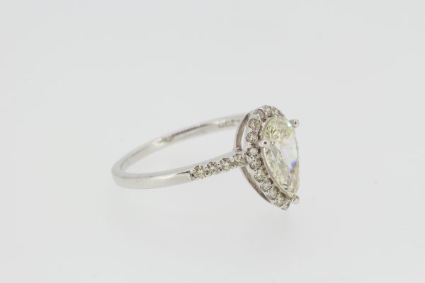Diamond and 18ct White Gold Pear Shaped Cluster Ring; featuring a central pear-cut diamond surrounded by diamonds, with diamond set shoulders