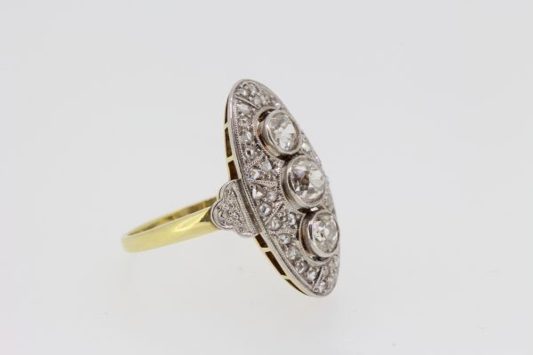 Art Deco Style Diamond Navette Cluster Plaque Ring; three central circular diamonds surrounded by rose-cut diamonds, to an 18ct yellow gold shank