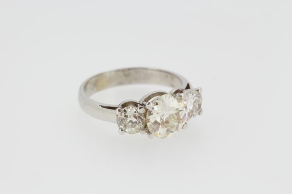 Three Stone Diamond Ring; featuring three circular cut diamonds, all claw set and mounted in 18ct white gold