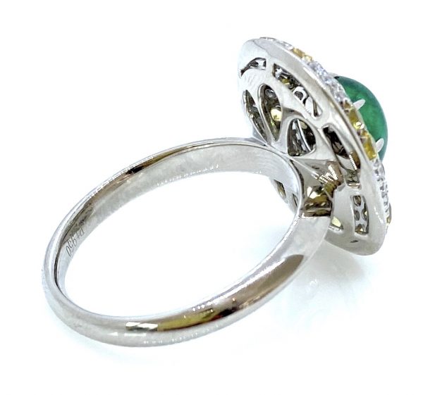 CabochCabochon Emerald and Diamond Cluster Ring in Platinum; 3.62ct cabochon-cut emerald with no oil within an oval diamond surround scattered with yellow sapphire accentson Emerald and Diamond Cluster Ring in Platinum; 3.62ct cabochon-cut emerald with no oil within an oval diamond surround scattered with fancy yellow diamond accents