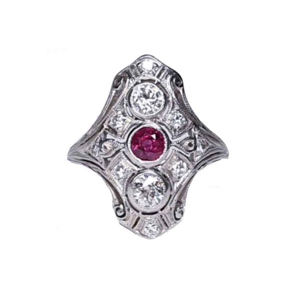 Antique Ruby and Diamond Plaque Dress Ring in Platinum; central 0.33ct ruby with a principal diamond above and below, set in a diamond-set openwork scroll design, 0.90cts total, Circa 1890