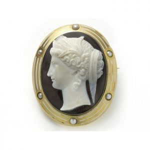 Antique Victorian Hera Cameo Sardonyx Natural Pearl and Gold Brooch; Hera the ancient Greek goddess on sardonyx hardstone cameo brooch, in 18ct yellow gold mount decorated with natural half pearls and white enamel, Circa 1890