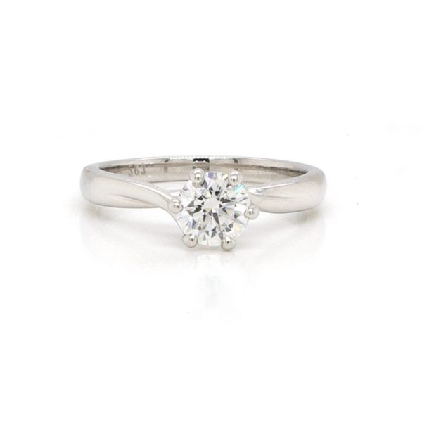 0.71ct Diamond Solitaire Engagement Ring in Platinum; six-claw set 0.71 carat round brilliant-cut diamond with diamond accent under mount, twists to shoulders