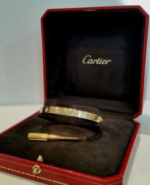 Cartier Love Bangle with Diamonds; 18ct yellow gold Cartier love bangle set with four brilliant-cut diamonds. Size 17. Comes with box, screwdriver and current valuation from Cartier