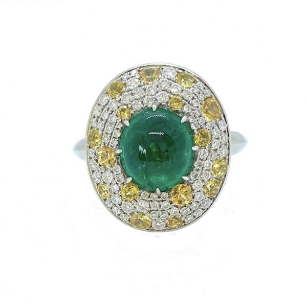 Cabochon Emerald and Diamond Cluster Ring in Platinum; 3.62ct cabochon-cut emerald with no oil within an oval diamond surround scattered with yellow sapphire accents