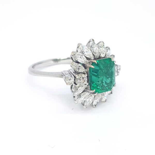 4ct Colombian Emerald and Marquise Diamond Floral Cluster Ring; central octagonal step-cut Colombian emerald surrounded by marquise-cut diamond petals, with brilliant-cut diamonds to the shoulders, 2cts diamonds, in 18ct white gold