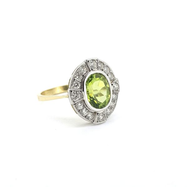 Peridot and Diamond Oval Cluster Ring in 18ct Gold; central 2ct oval faceted mixed-cut peridot within a 0.50ct diamond surround