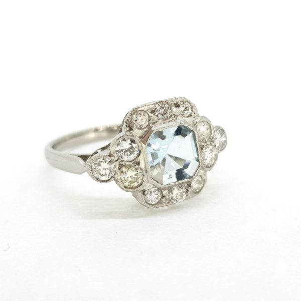 Aquamarine and Diamond Cluster Ring in Platinum; featuring a 0.80ct octagonal step-cut aquamarine surrounded by 0.60cts diamonds