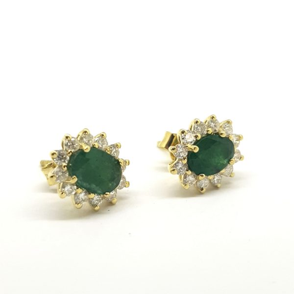 Emerald and Diamond Oval Cluster Stud Earrings; featuring 1.25cts oval-cut emeralds surrounded by 0.60cts brilliant-cut diamonds, in 18ct yellow gold