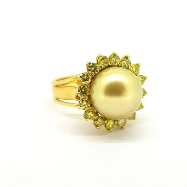 Golden South Sea Pearl and Yellow Diamond Cluster Ring; central 13mm golden South Sea pearl set within a border of 2cts fancy yellow diamonds, in 18ct yellow gold