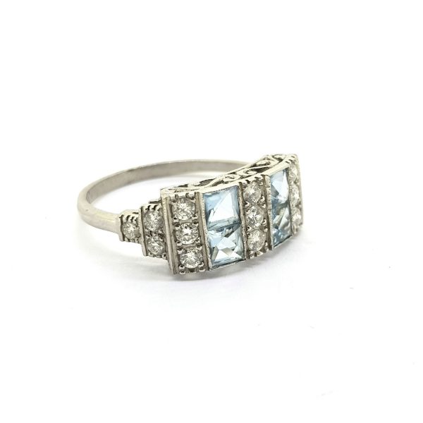 Art Deco Style Aquamarine and Diamond Dress Ring in Platinum; featuring vertical rows of French-cut aquamarines alternated with rows of diamonds, with graduated stepped diamond set shoulders
