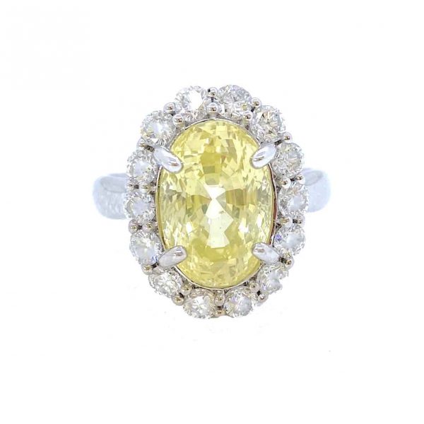 Yellow Sapphire and Diamond Oval Cluster Ring; 6.42ct Sri Lankan oval yellow sapphire with no heat treatment surrounded by 1.16cts diamonds, in 18ct white gold