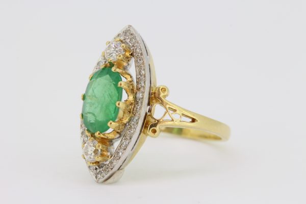 Emerald and Diamond Marquise Shaped Navette Cluster Ring; central oval emerald within an open marquise-shaped border of diamonds with two main diamonds top and bottom, in 18ct yellow gold with split scrolled shoulders