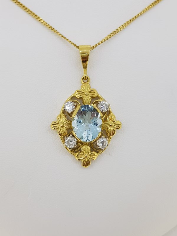 Vintage 1940s Aquamarine and Diamond Pendant; central oval aquamarine surrounded by four sparkling diamonds and four gold flowers, in 18ct yellow gold