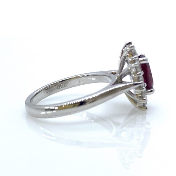 Burmese Ruby and Diamond Cluster Ring; 1.01ct oval faceted Burma ruby surrounded by 0.65cts diamonds, 18ct white gold. No indication of heat treatment
