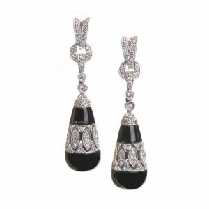 Black Onyx and Diamond Drop Earrings; torpedo-shaped black onyx drops, with diamond-set cut-out mid-section and suspended by diamond links, in 18ct white gold