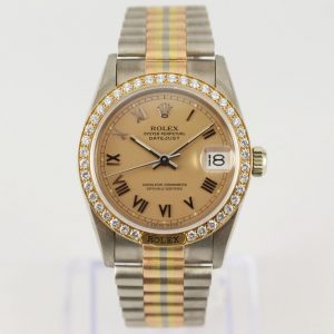 Rare Rolex Tridor 68149 Midsize 18ct Yellow Gold Watch with Original Diamond Bezel; bronze-champagne dial with Roman numeral hour markers and a date aperture at 3, with Rolex box
