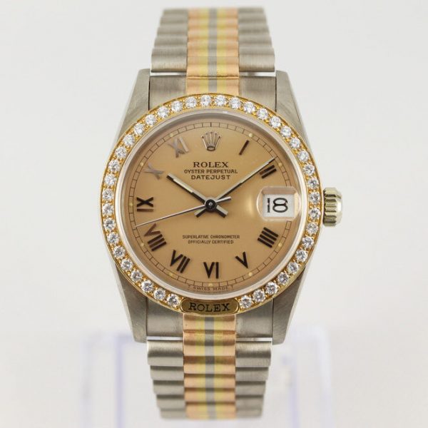 Rare Rolex Tridor 68149 Midsize 18ct Yellow Gold Watch with Original Diamond Bezel; bronze-champagne dial with Roman numeral hour markers and a date aperture at 3, with Rolex box