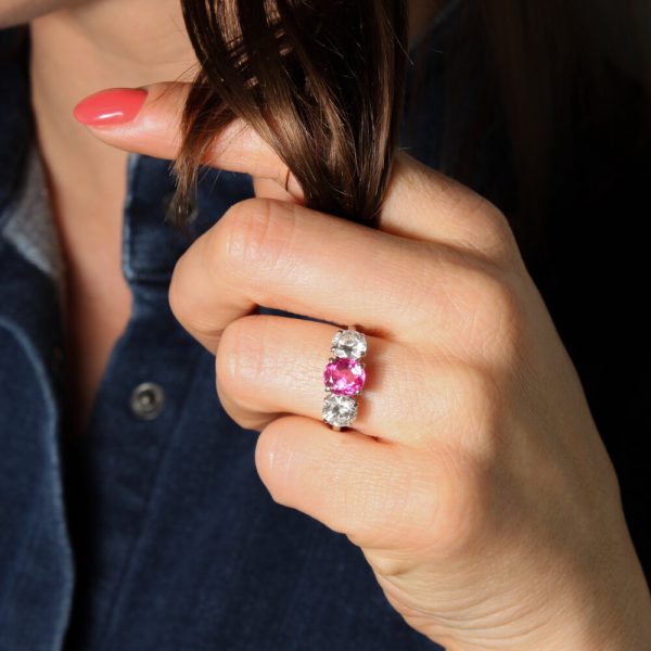 Natural Pink Sapphire and Diamond Three Stone Ring; central 1.50ct natural pink sapphire flanked by 2cts round brilliant-cut diamonds, all claw set in platinum